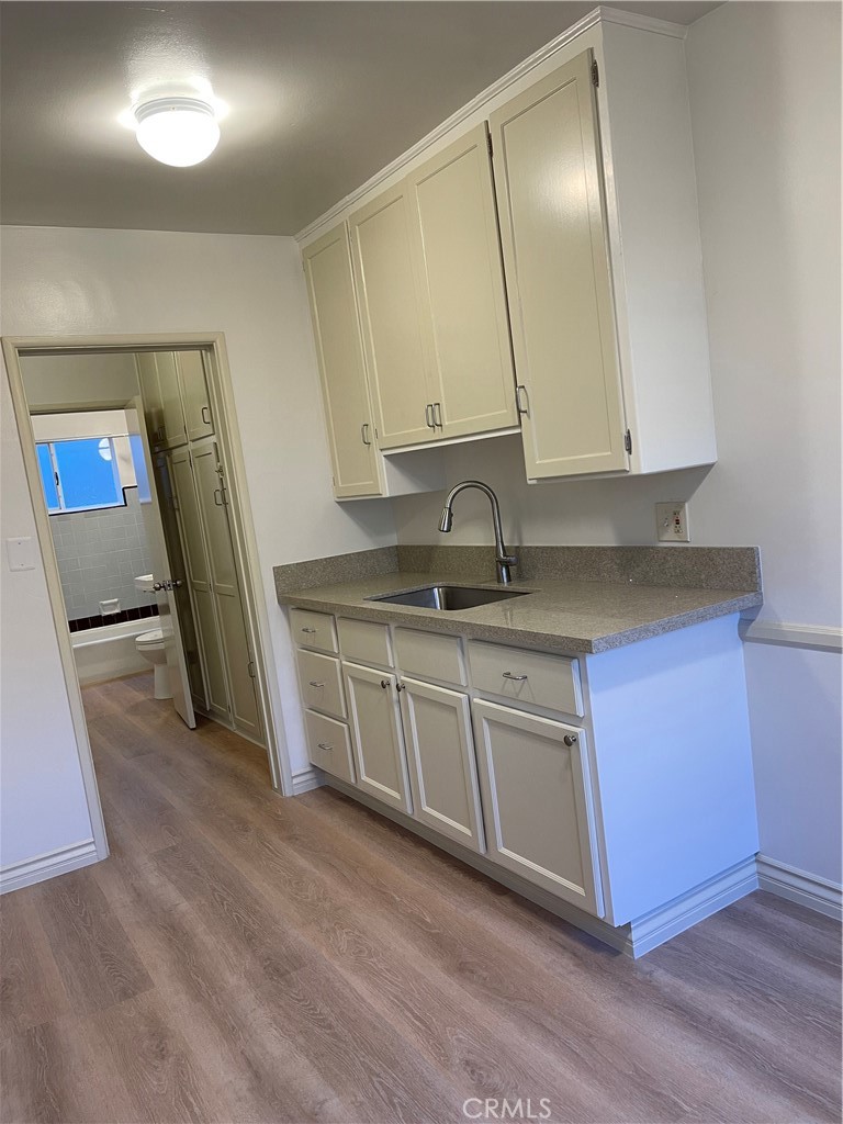 970 Elden Avenue, Unit 3 Los Angeles, CA 90006 - Photo 5 of 10 a kitchen with stainless steel appliances granite countertop a sink and a stove top oven