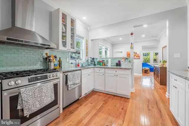 a kitchen with a stove a sink and a refrigerator