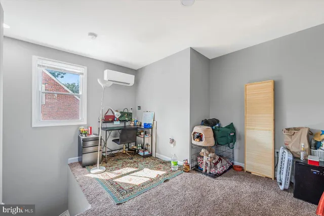 a view of a room with workspace and a window