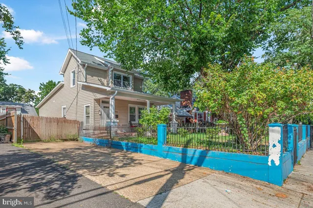 a front view of a house with a yard and garden