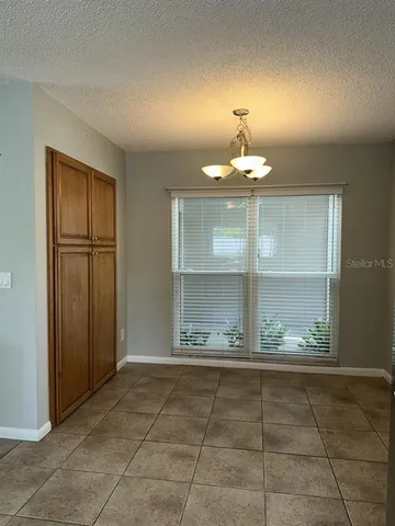 a kitchen with a sink window and stainless steel appliances