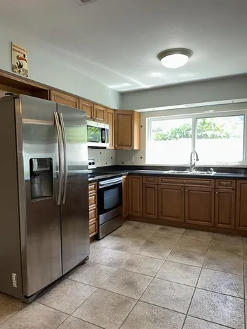 a kitchen with stainless steel appliances granite countertop a sink and cabinets