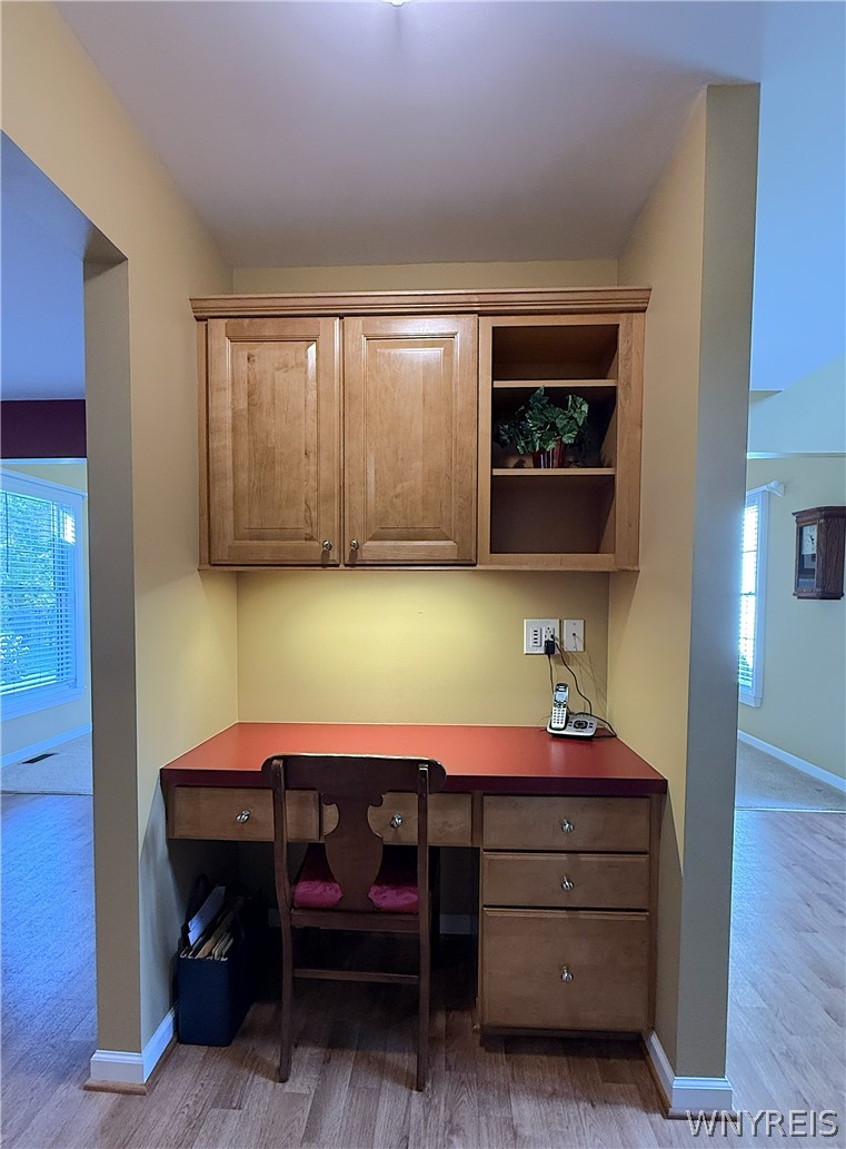 73 Chestnut Lancaster, NY 14086 - Photo 10 of 41 A dedicated home office nook features custom wood cabinetry and built-in desk space.
