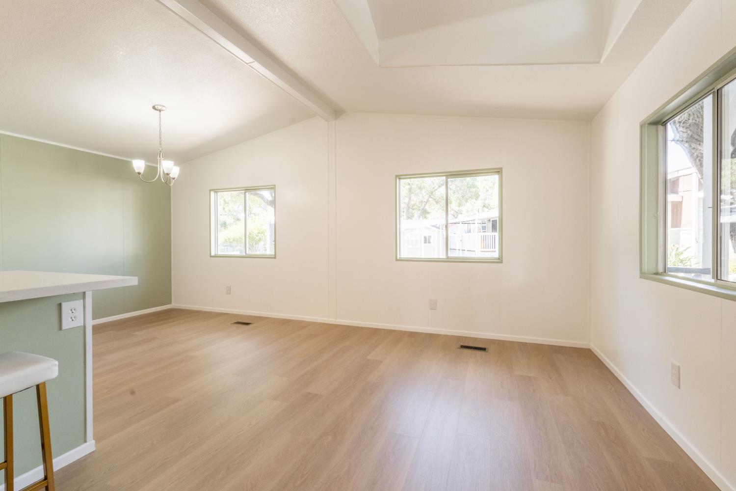 1273 South Rice Road, Unit 4 Ojai, CA 93023 - Photo 6 of 26 an empty room with wooden floor and windows