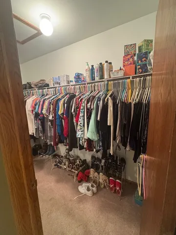 a view of walk in closet with clothes