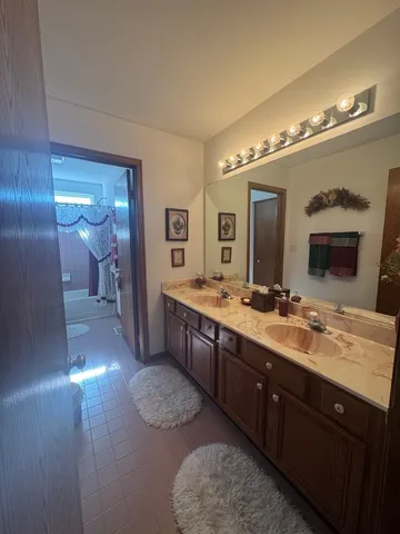 a spacious bathroom with a double vanity sink and a mirror