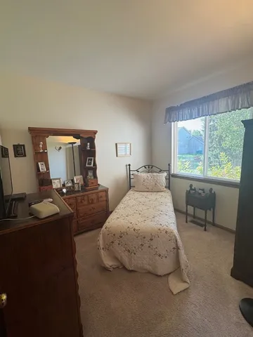 a bedroom with two beds and a large window