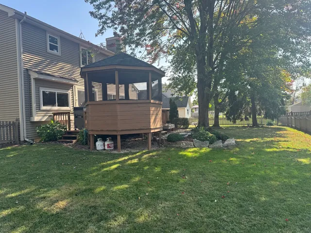 a view of a house with a yard and sitting area
