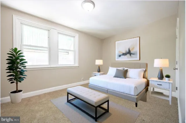 a bedroom with a bed and a potted plant