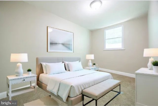 a bedroom with a bed and a lamp