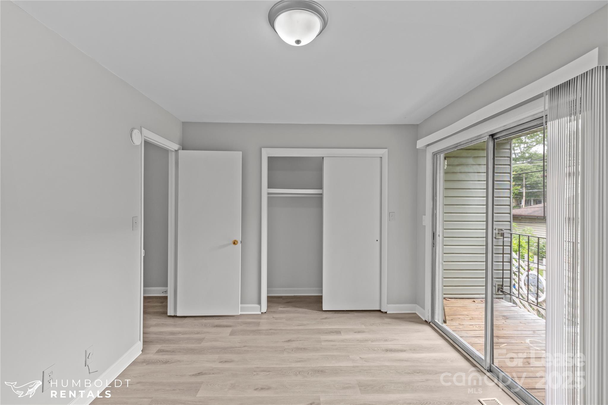 301 Eagle Road, Unit 2 Belmont, NC 28012 - Photo 11 of 15 an empty room with wooden floor and windows