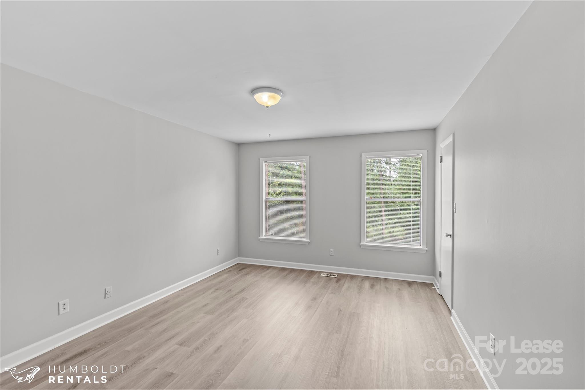 301 Eagle Road, Unit 2 Belmont, NC 28012 - Photo 7 of 15 an empty room with wooden floor and windows