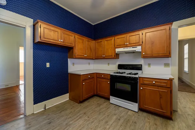 an empty room with wooden floor and closet