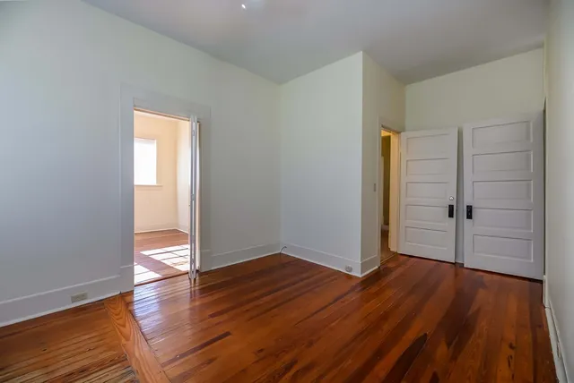 a view of a kitchen with wooden floor and a sink