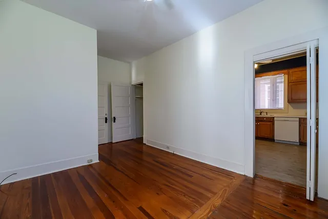 a view of a room with wooden floor and natural light