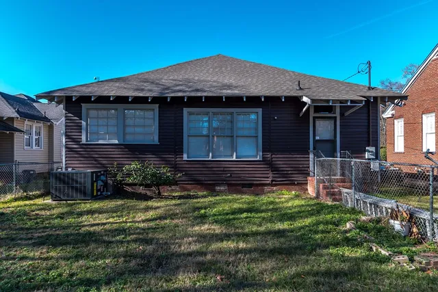 a view of house with backyard