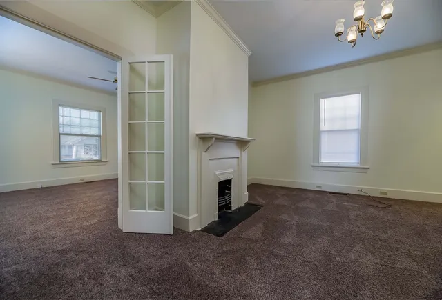 an empty room with windows and closet