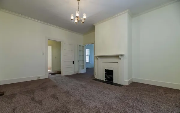a view of a livingroom with a fireplace and window