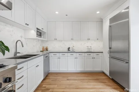 a kitchen with a potted plant on the counter and cabinets