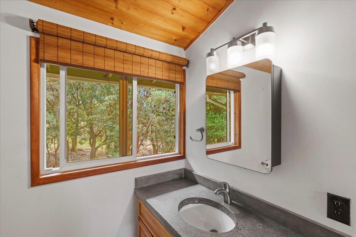 31 Hapapa Road, Unit B Kula, HI 96790 - Photo 31 of 50 a bathroom with a granite countertop sink a toilet and a window