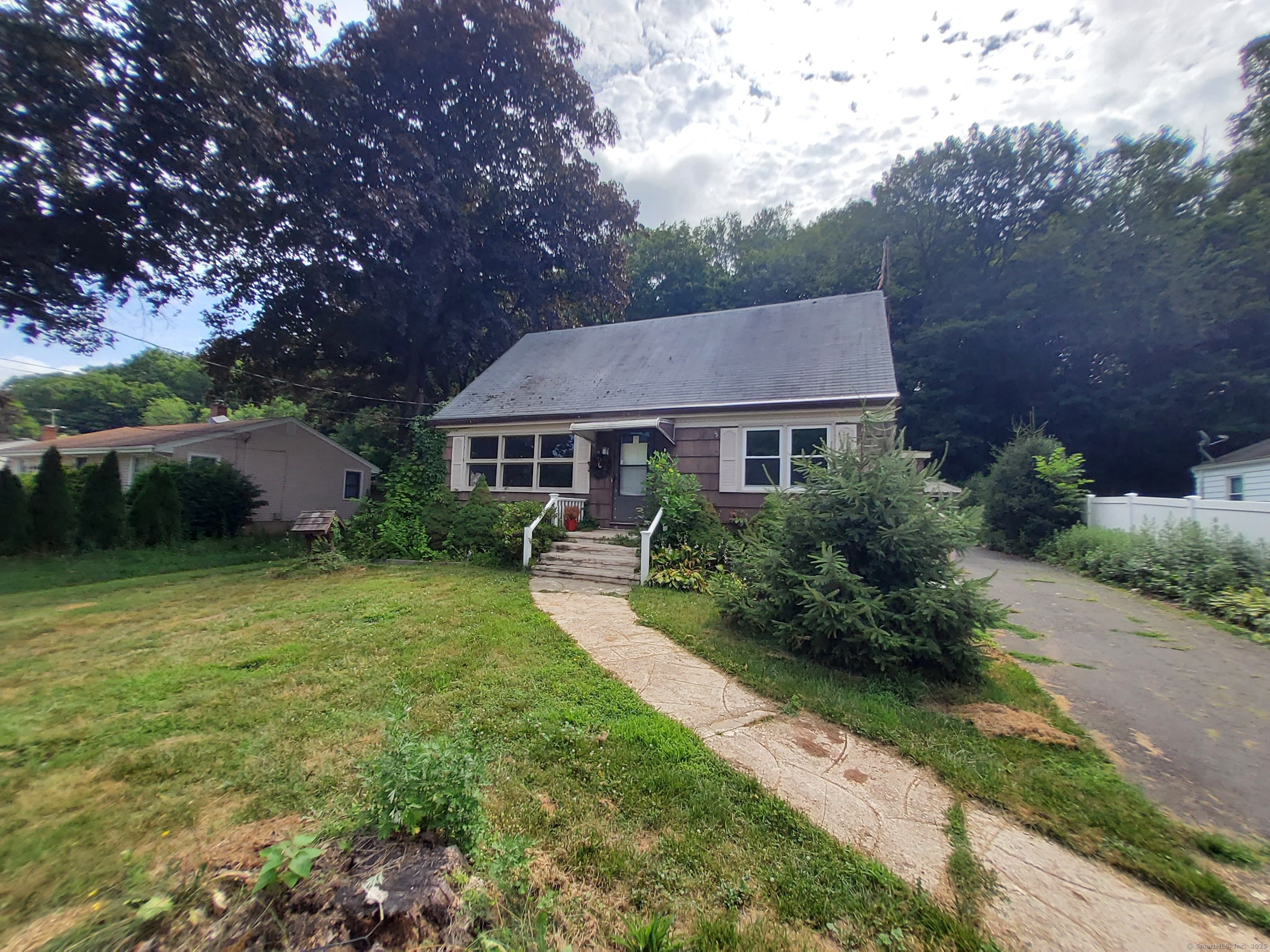 707 Circular Avenue Hamden, CT 06514 - Photo 1 of 1 a front view of a house with a yard and green space