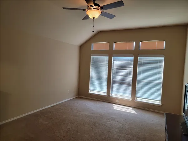 a view of a livingroom with a ceiling fan and window