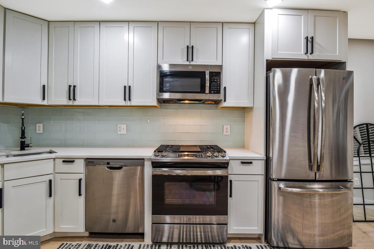 1028 Bladensburg Road Northeast, Unit 5 Washington, DC 20002 - Photo 11 of 29 a kitchen with a stove and a refrigerator