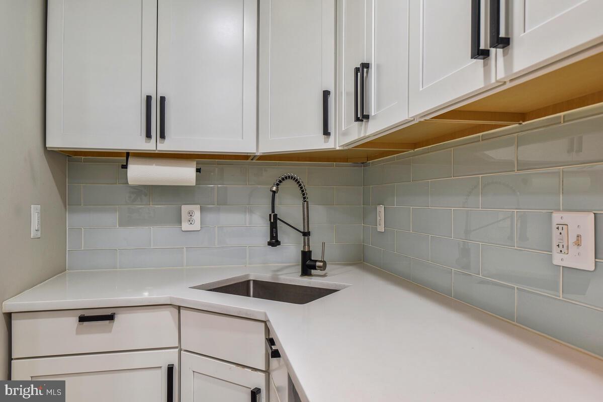 1028 Bladensburg Road Northeast, Unit 5 Washington, DC 20002 - Photo 12 of 29 a kitchen with stainless steel appliances granite countertop a sink and cabinets