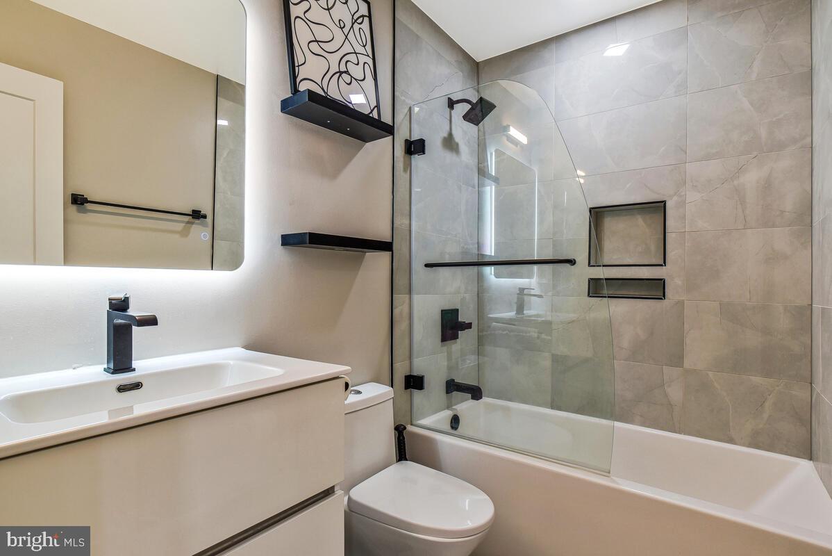 1028 Bladensburg Road Northeast, Unit 5 Washington, DC 20002 - Photo 16 of 29 a bathroom with a sink a toilet and shower