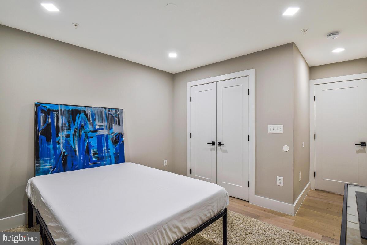 1028 Bladensburg Road Northeast, Unit 5 Washington, DC 20002 - Photo 18 of 29 a bedroom with a large bed and a chandelier