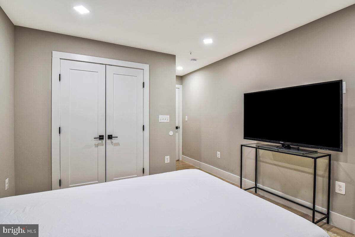 1028 Bladensburg Road Northeast, Unit 5 Washington, DC 20002 - Photo 19 of 29 a bedroom with a bed and a flat screen tv