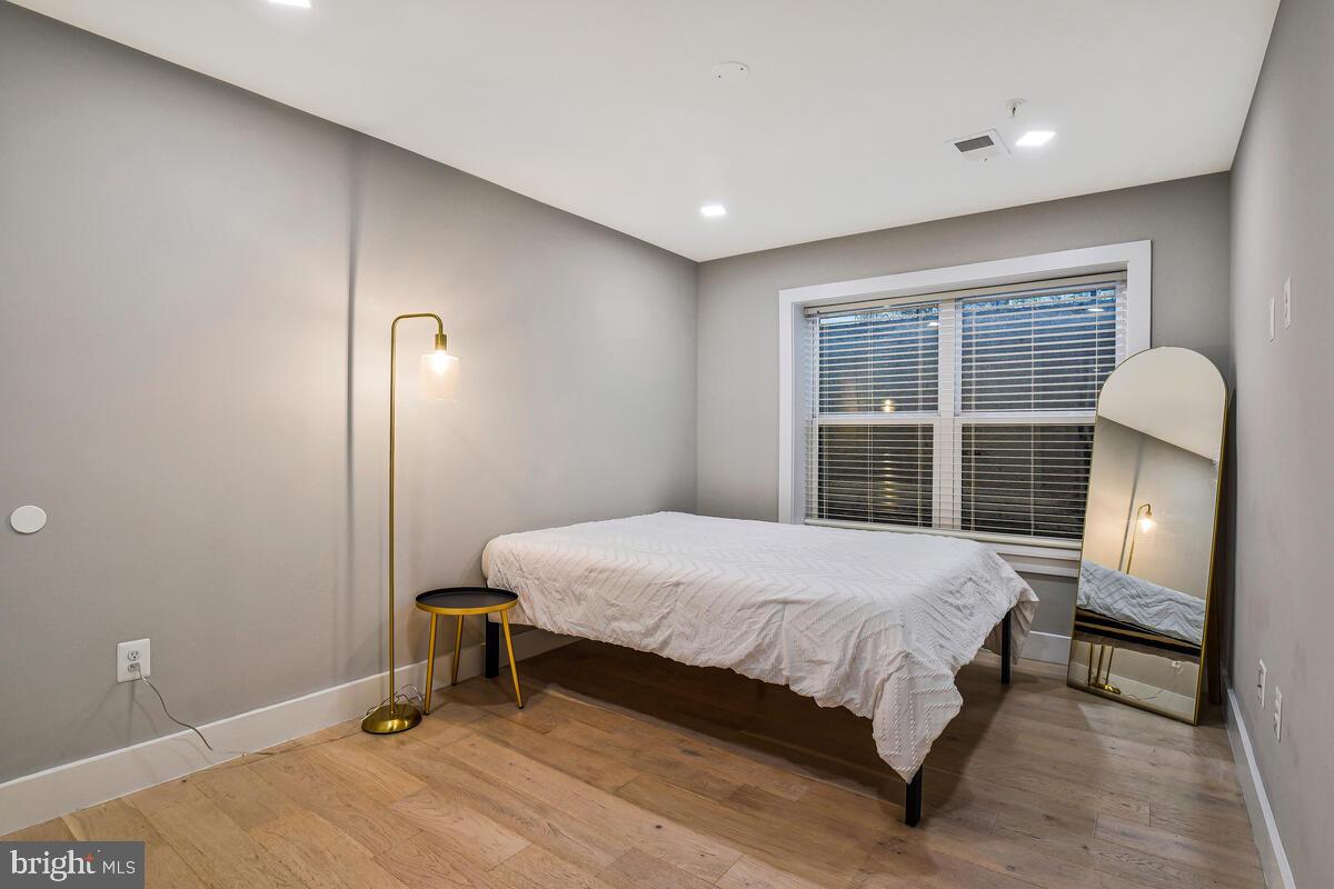 1028 Bladensburg Road Northeast, Unit 5 Washington, DC 20002 - Photo 20 of 29 a bedroom with a bed table and a window