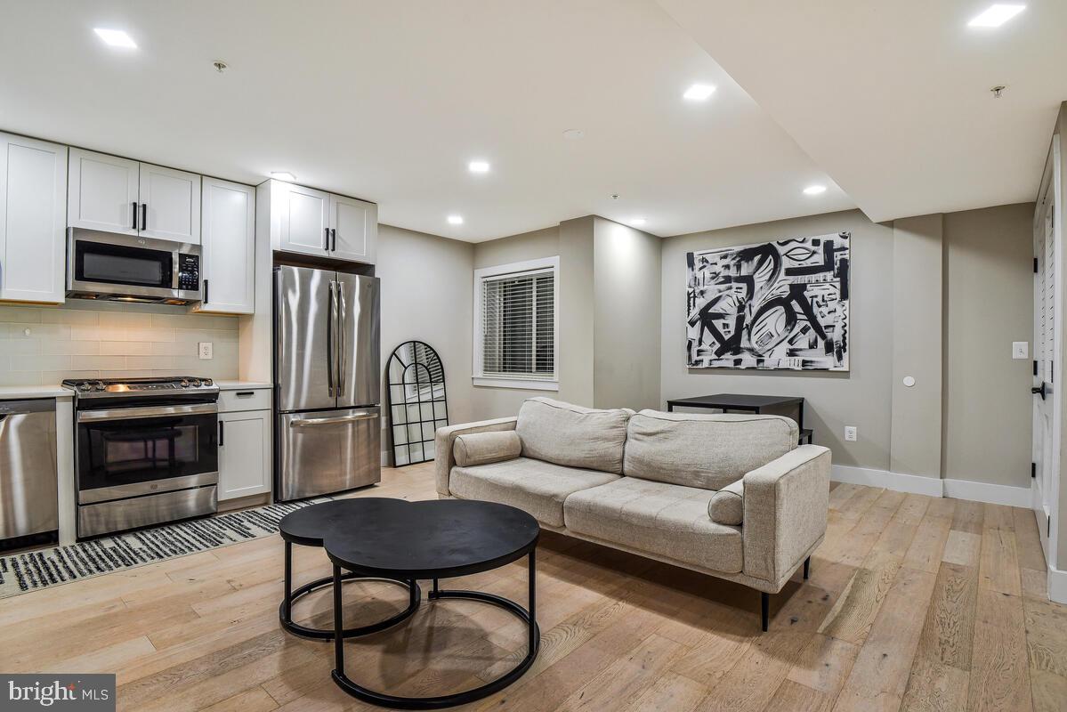 1028 Bladensburg Road Northeast, Unit 5 Washington, DC 20002 - Photo 3 of 29 a living room with furniture and a wooden floor