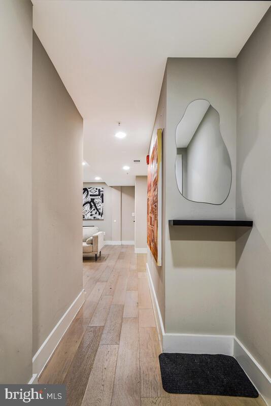 1028 Bladensburg Road Northeast, Unit 5 Washington, DC 20002 - Photo 5 of 29 a view of a hallway with a couch and a potted plant next to a window