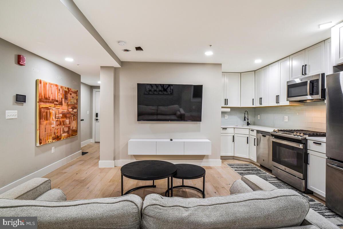 1028 Bladensburg Road Northeast, Unit 5 Washington, DC 20002 - Photo 6 of 29 a living room with furniture and a flat screen tv