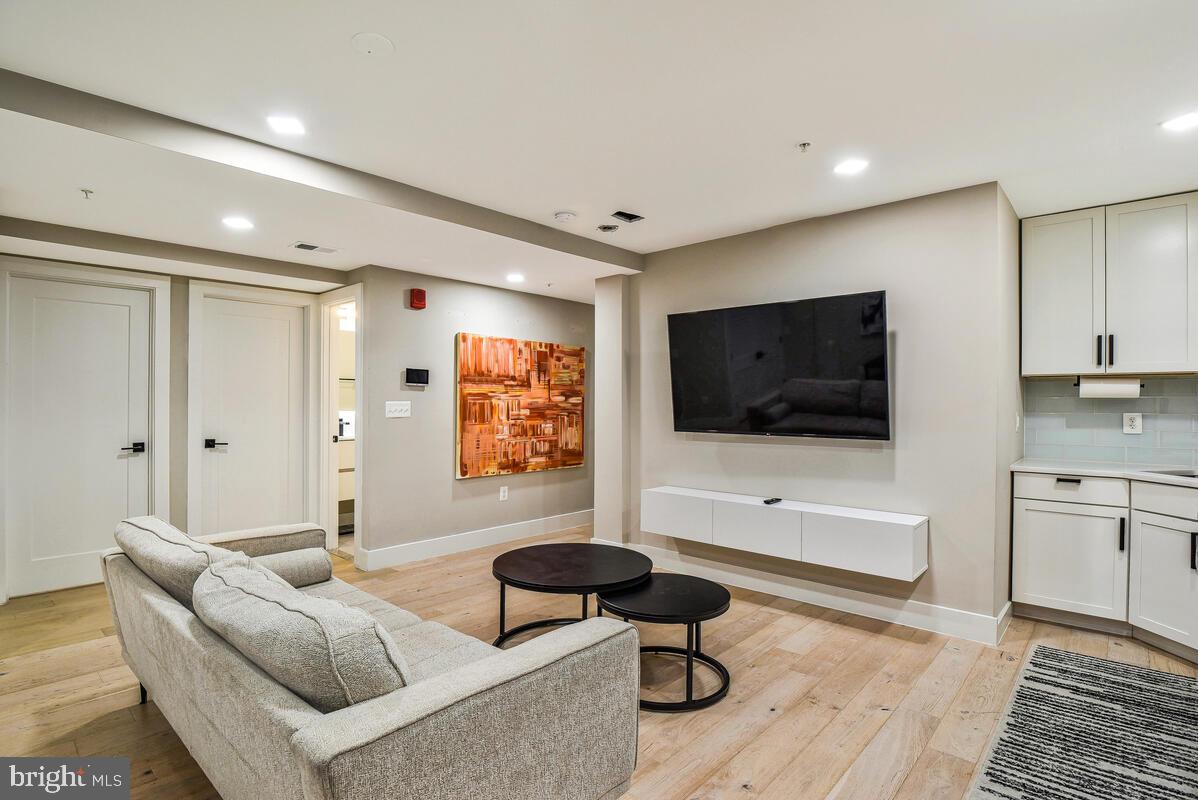 1028 Bladensburg Road Northeast, Unit 5 Washington, DC 20002 - Photo 7 of 29 a living room with furniture and a flat screen tv