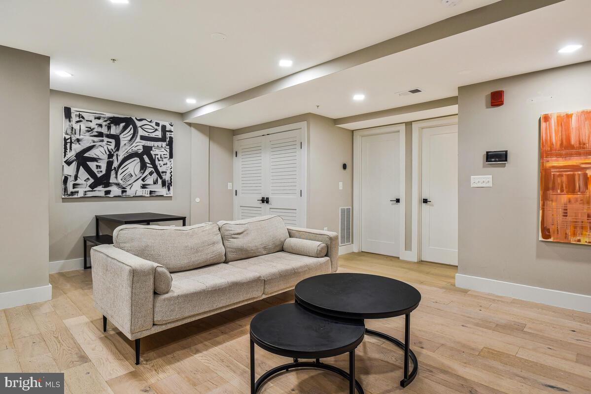 1028 Bladensburg Road Northeast, Unit 5 Washington, DC 20002 - Photo 8 of 29 a living room with furniture and a wooden floor