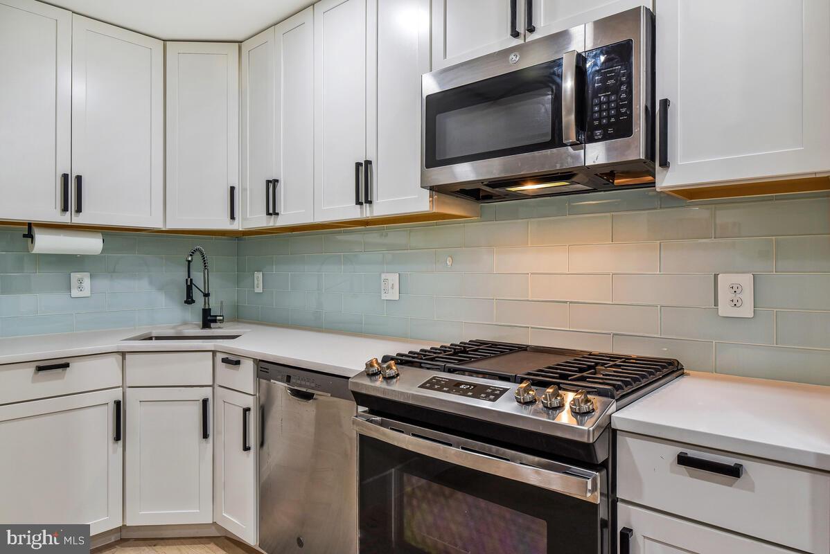 1028 Bladensburg Road Northeast, Unit 5 Washington, DC 20002 - Photo 9 of 29 a kitchen with granite countertop a stove and a microwave