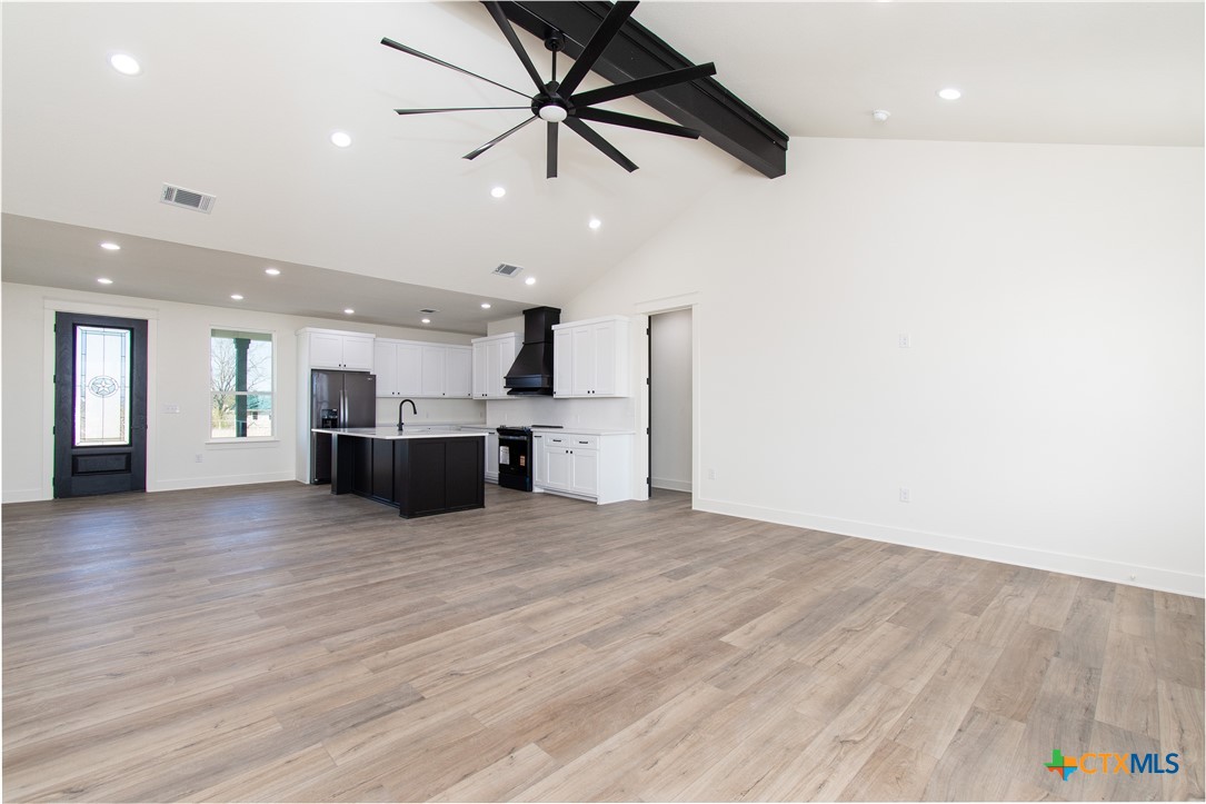 4245 Stringtown Road Temple, TX 76501 - Photo 4 of 25 a view of empty room with wooden floor and ceiling fan