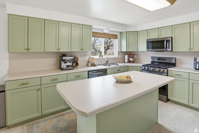 5108 South 2000th Street West Roy, UT 84067 - Photo 21 of 61 Kitchen featuring green cabinets, stainless steel appliances, and light countertops