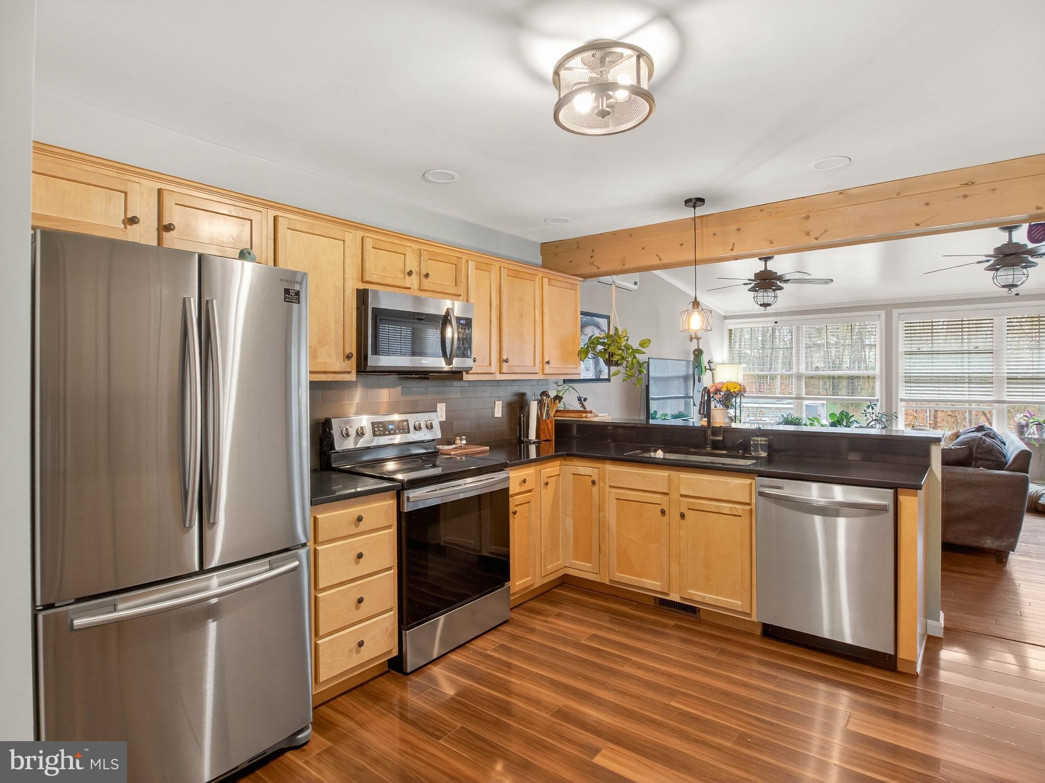 2586 West Hoover Road Haywood, VA 22722 - Photo 11 of 35 a kitchen with stainless steel appliances granite countertop a refrigerator a stove a sink and a microwave