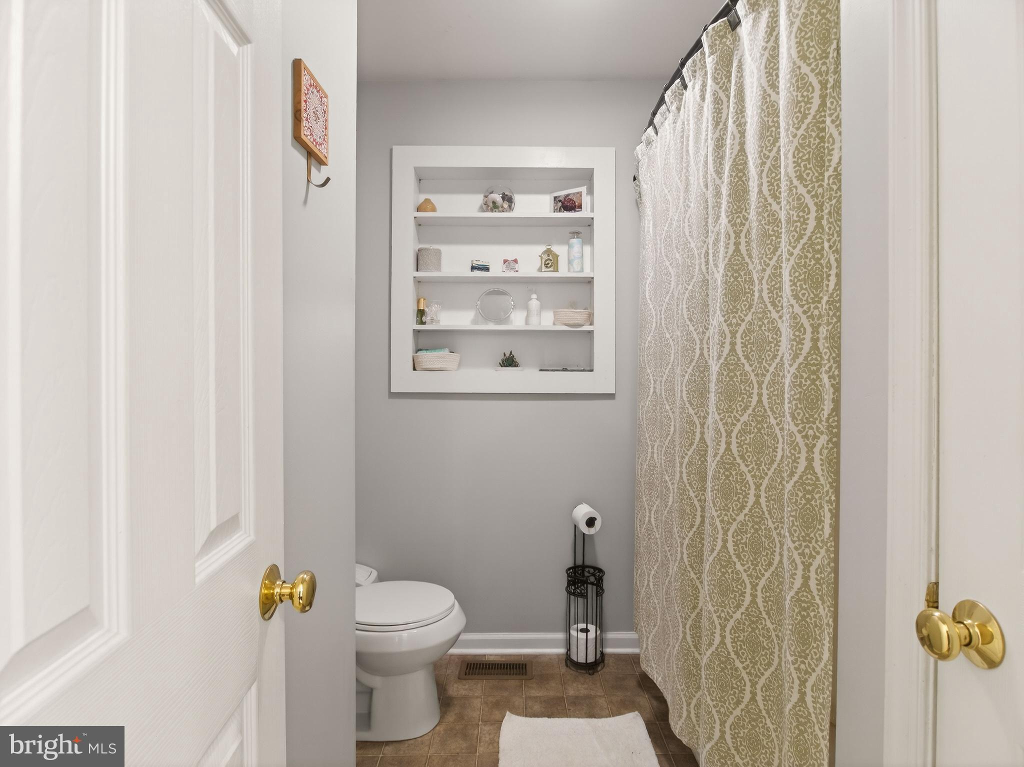 2586 West Hoover Road Haywood, VA 22722 - Photo 24 of 35 a bathroom with a toilet and a shower curtain