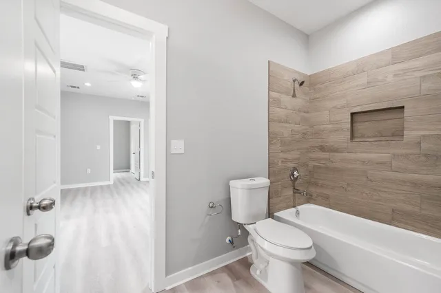 a bathroom with a toilet and a shower