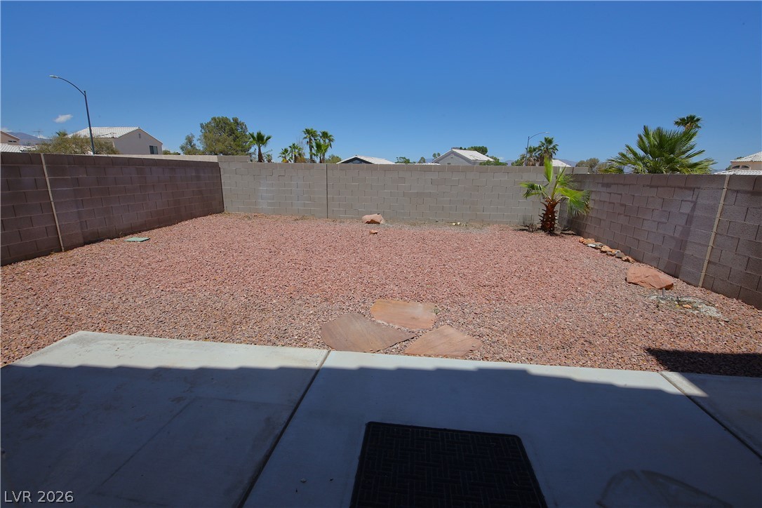 8220 Maplestar Road Las Vegas, NV 89128 - Photo 26 of 29 An enclosed private yard features low-maintenance xeriscaping with a concrete patio.