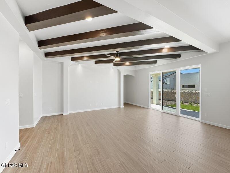 7248 Cimarron Rim Drive El Paso, TX 79911 - Photo 21 of 48 a view of an empty room with wooden floor and a window