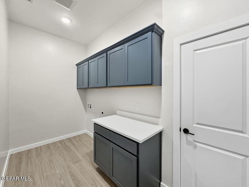 7248 Cimarron Rim Drive El Paso, TX 79911 - Photo 46 of 48 a view of a storage and utility room with wooden floor