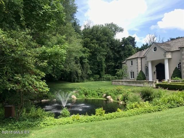 36 Perkins Road Greenwich, CT 06830 - Photo 12 of 26 a view of a house with a yard and a garden