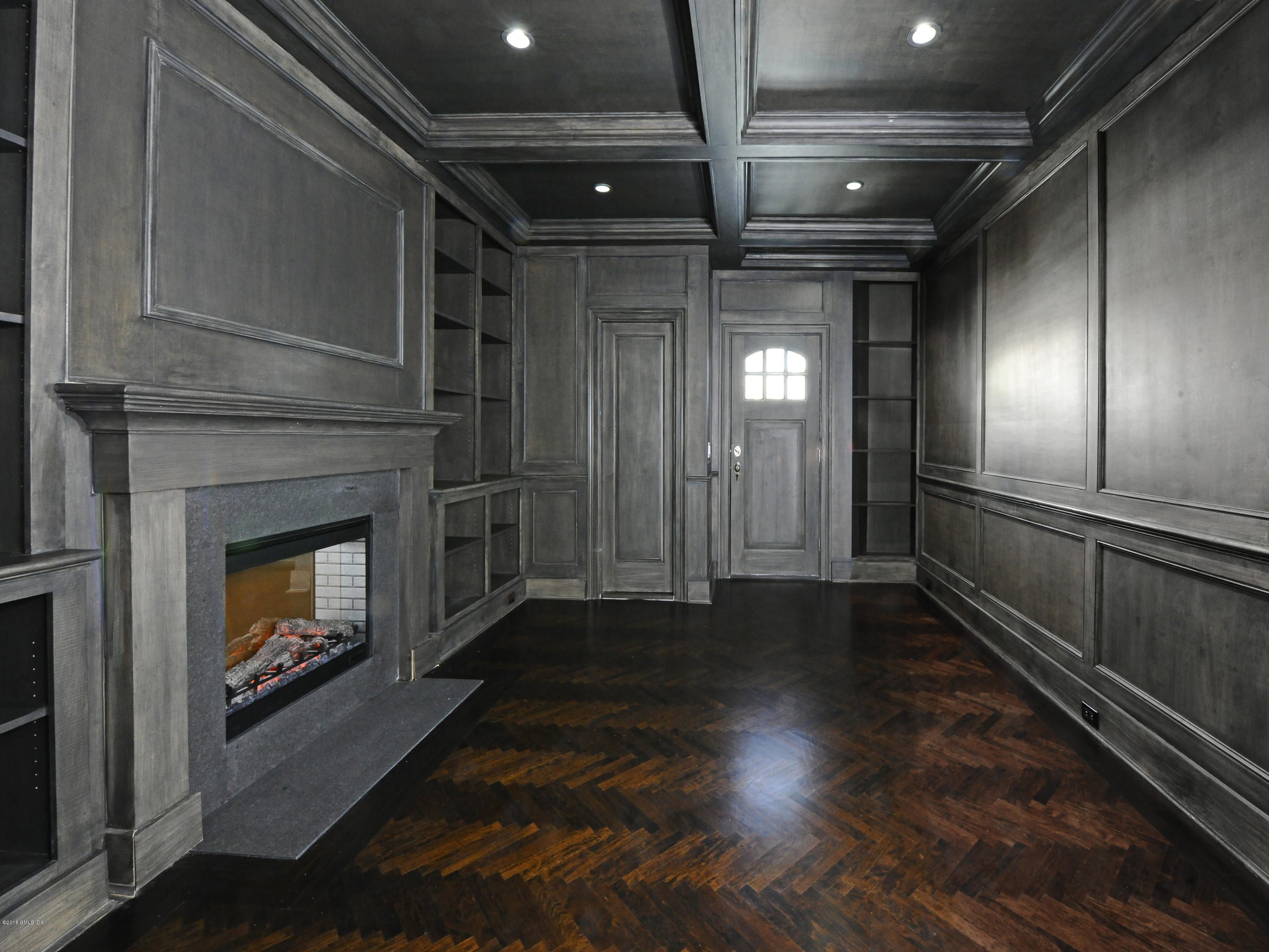 36 Perkins Road Greenwich, CT 06830 - Photo 20 of 26 a view of an empty room with wooden floor a fireplace and windows