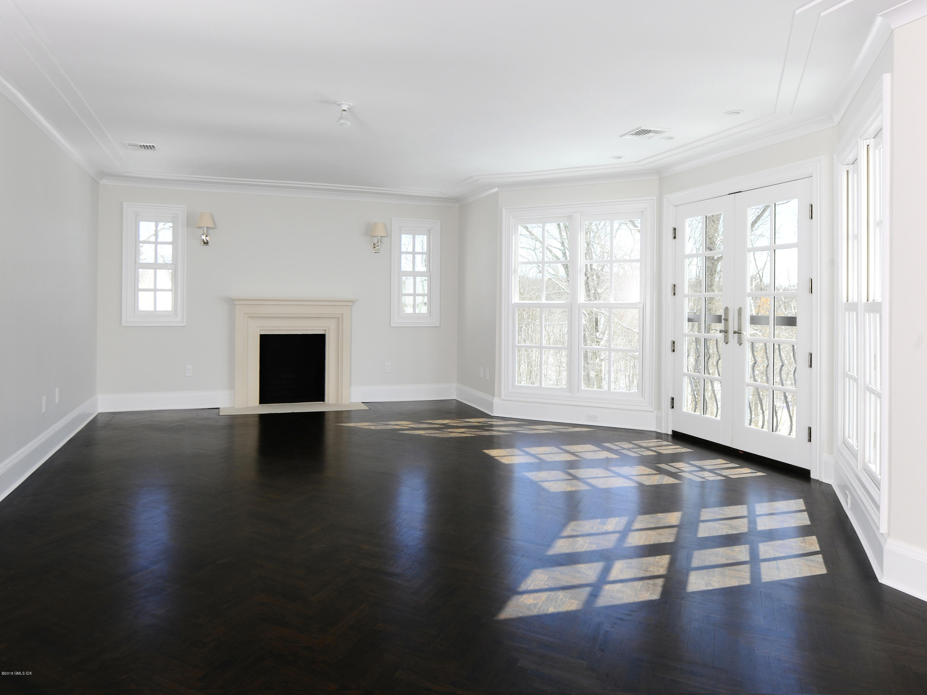 36 Perkins Road Greenwich, CT 06830 - Photo 23 of 26 a view of empty room with wooden floor and fireplace