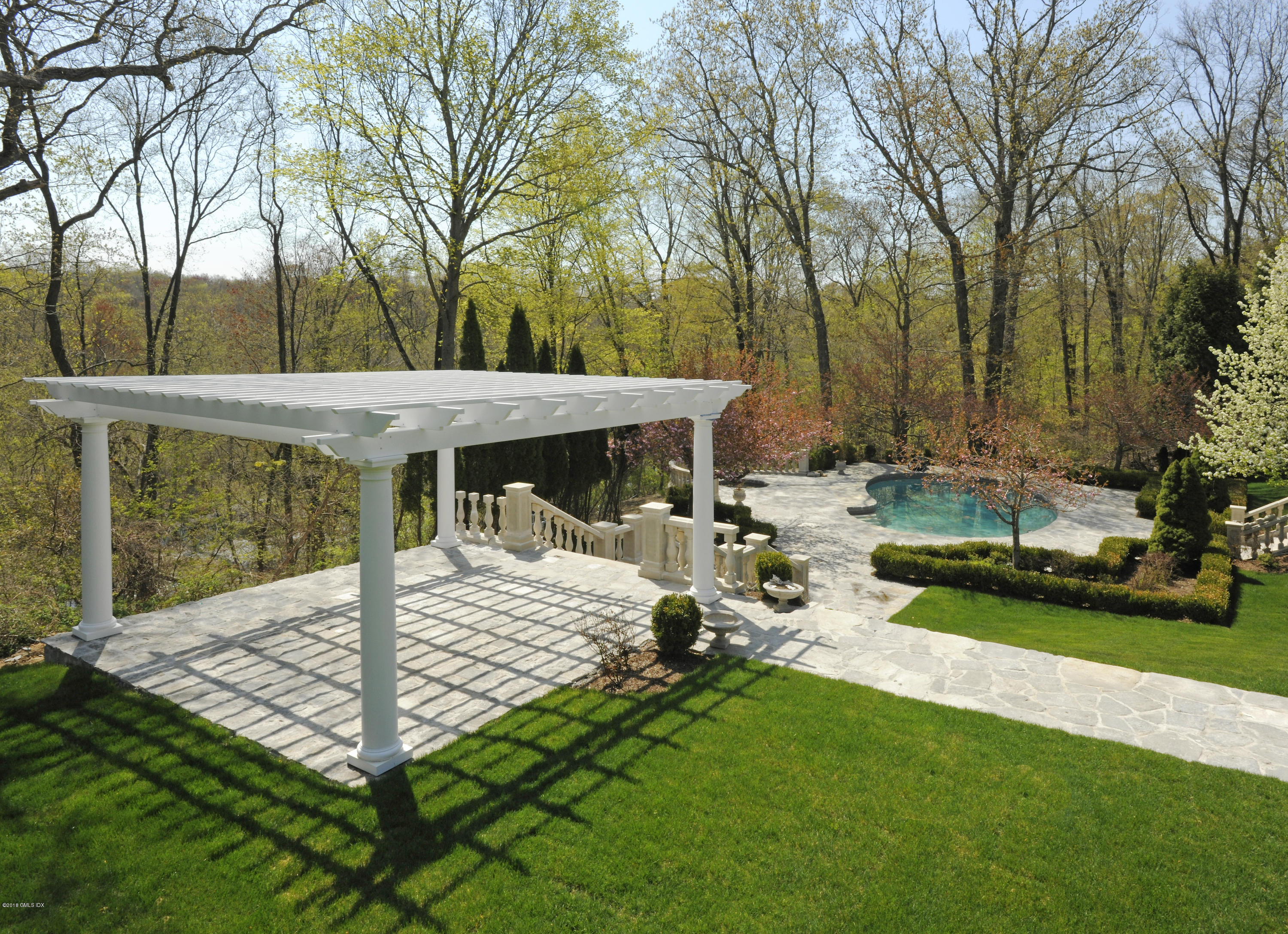 36 Perkins Road Greenwich, CT 06830 - Photo 6 of 26 a view of a patio with table and chairs under an umbrella